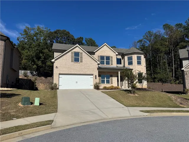 a view of a house with a yard and street view
