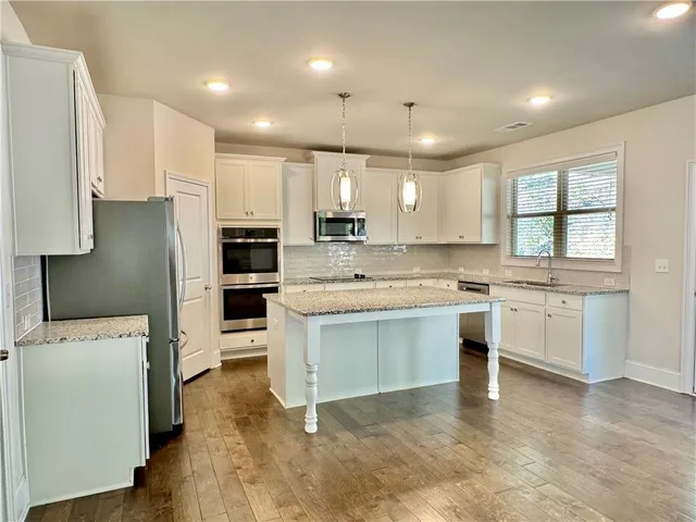 a kitchen with a refrigerator sink and stove