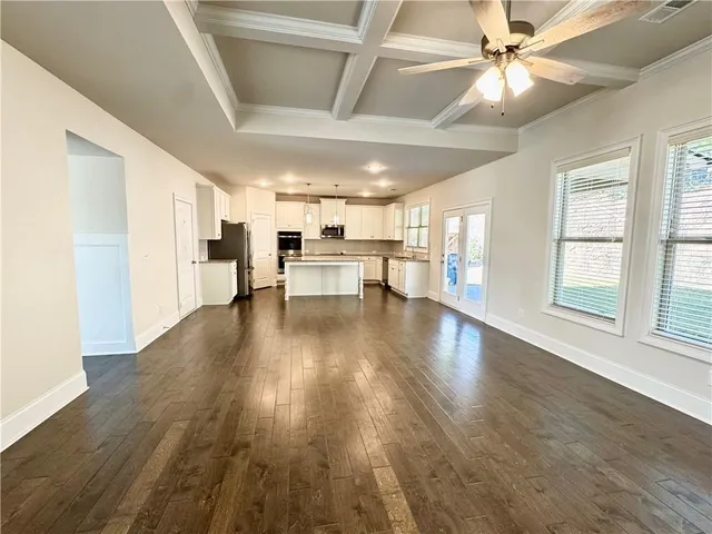 a view of a livingroom with hardwood floor and a ceiling fan