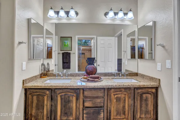 a bathroom with a sink double vanity and a mirror
