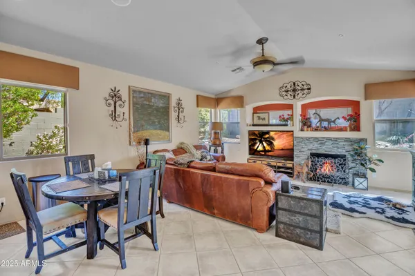 a living room with furniture a fireplace and a large window