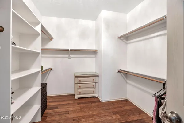 a view of walk in closet with empty racks