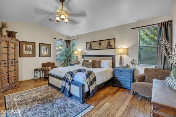 a bedroom with a bed wooden floor and window