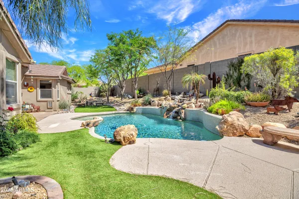 a view of a backyard with tree