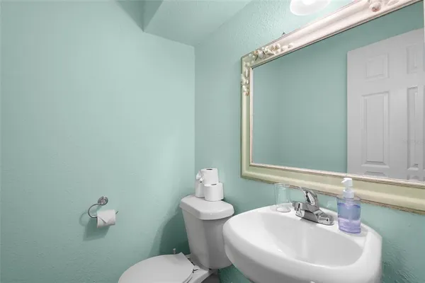 a bathroom with a sink a mirror and a toilet
