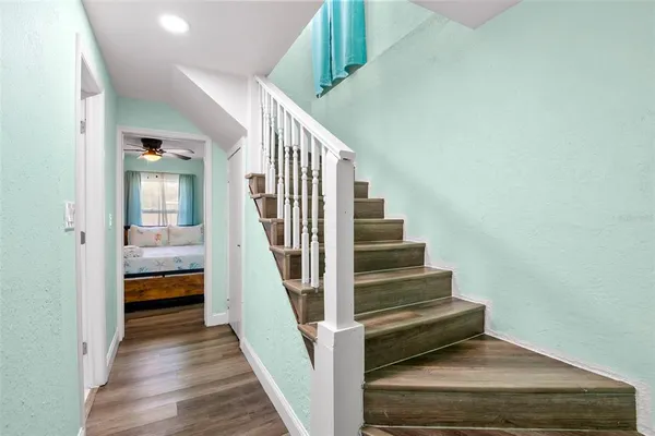a view of entryway and hall with wooden floor