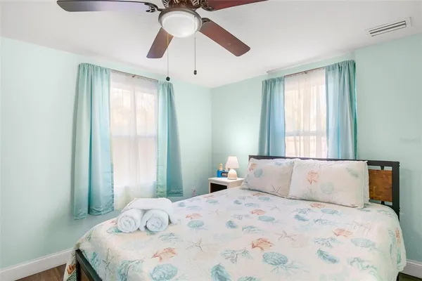 a bedroom with a large bed and a chandelier