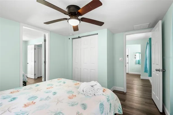 a bedroom with a bed and a chandelier