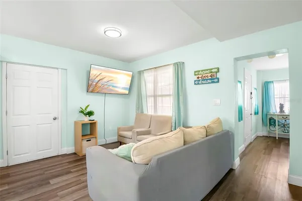 a living room with furniture and wooden floor