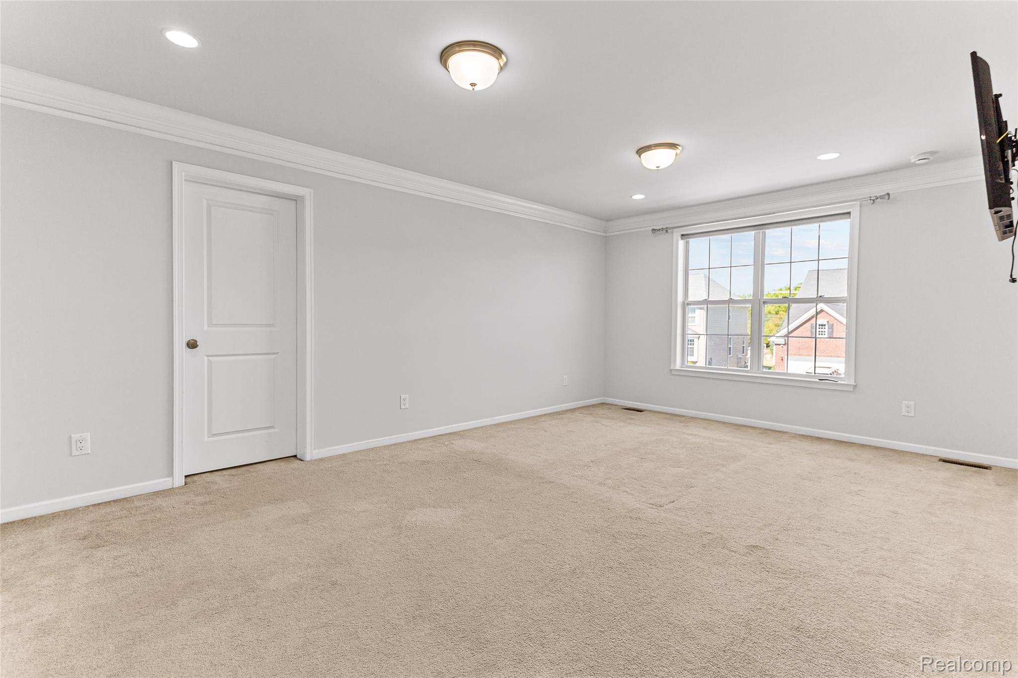 50873 Scarborough Road Canton, MI 48188 - Photo 9 of 25 Recessed lighting, crown molding, double-pane window, and carpeted flooring
