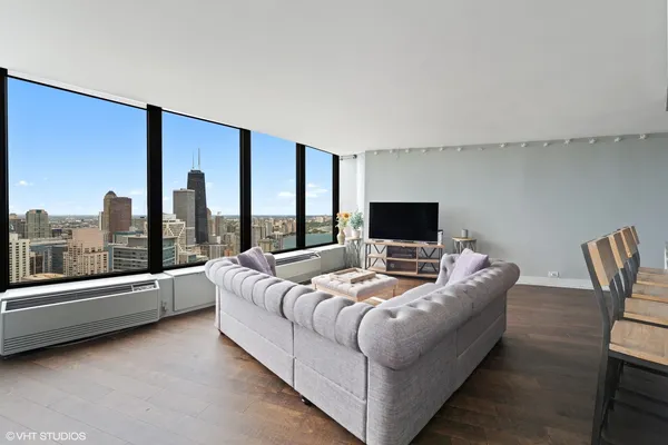 a living room with furniture and a large window