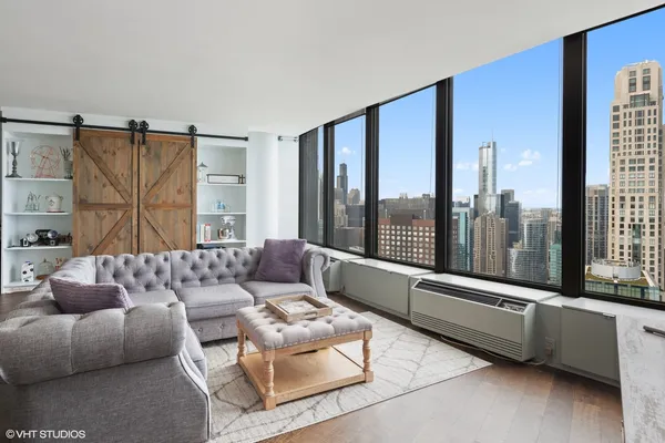 a kitchen with stainless steel appliances kitchen island granite countertop a table chairs and a refrigerator