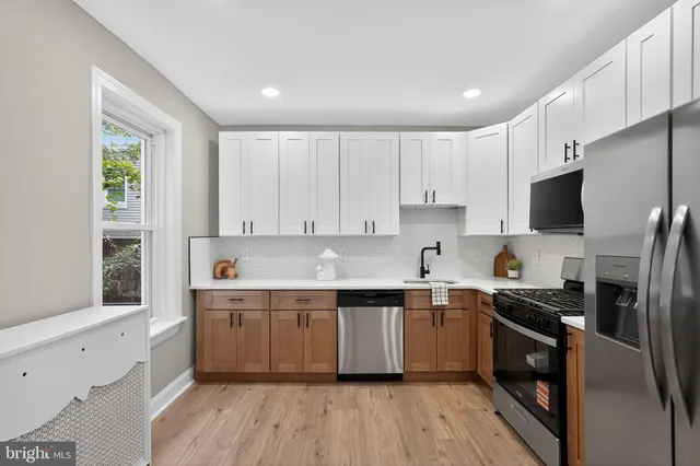 a kitchen with a sink cabinets and stainless steel appliances