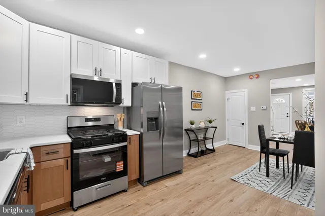 a kitchen with stainless steel appliances a stove a refrigerator and a refrigerator