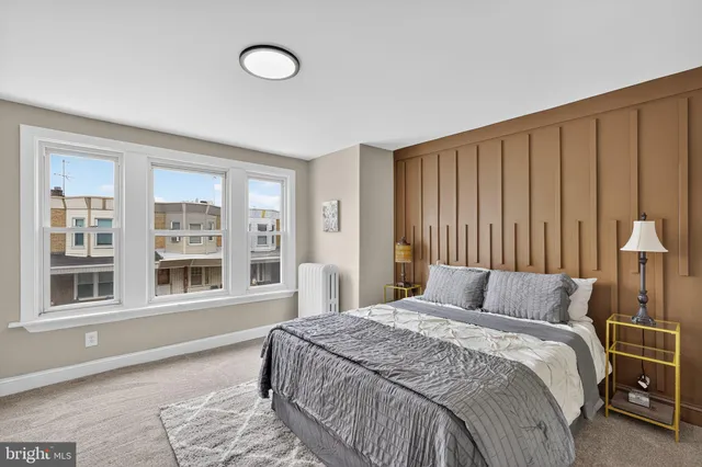 a bedroom with a large bed and a large window