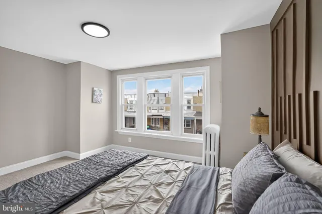 a bedroom with a bed and a window