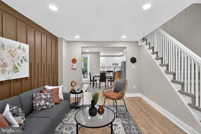 a living room with furniture and wooden floor