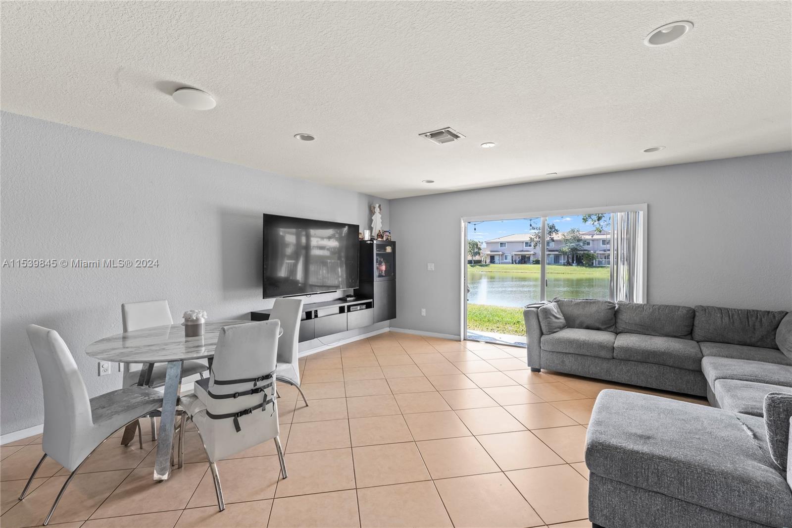 5931 Abbey Road Tamarac, FL 33321 - Photo 3 of 14 a living room with furniture and a flat screen tv