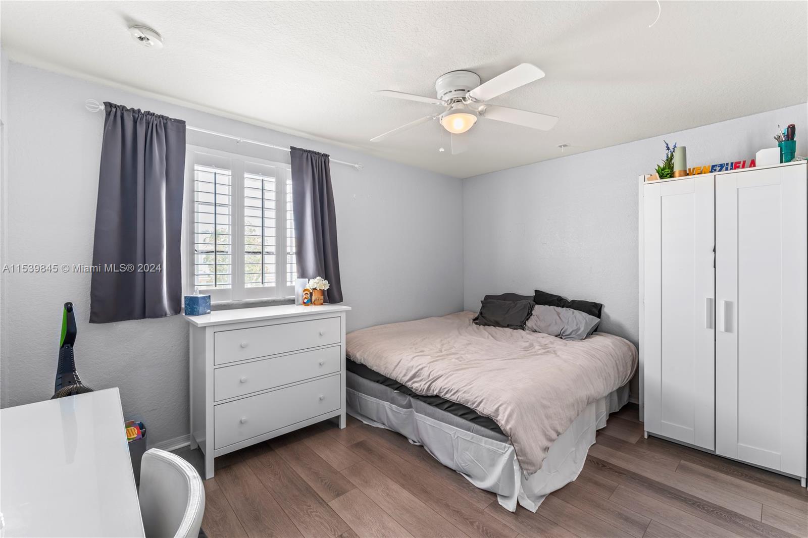 5931 Abbey Road Tamarac, FL 33321 - Photo 8 of 14 a bedroom with a bed and a window
