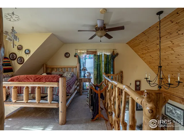 a bedroom with two beds and a large window