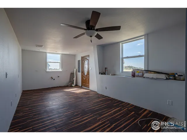 a view of an empty room with a ceiling fan