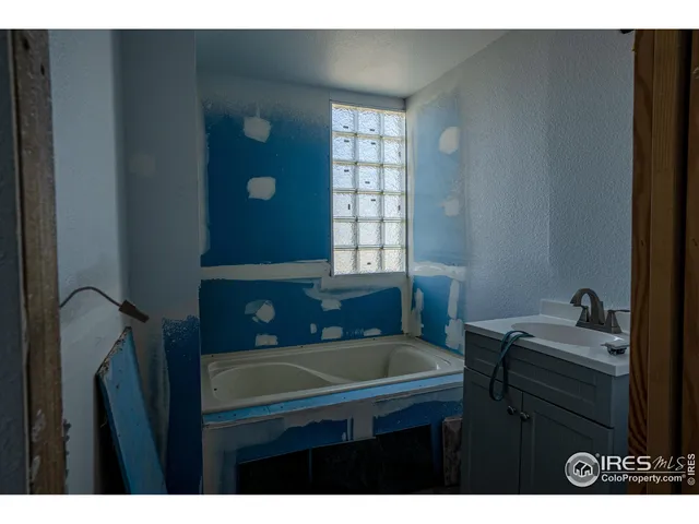 a view of backyard of house and car parked