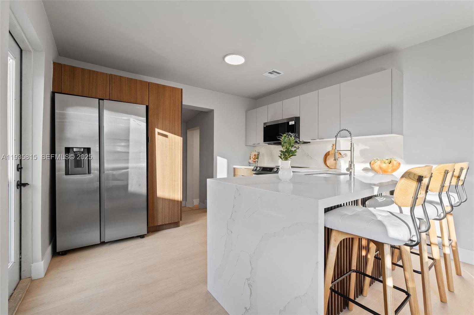 2439 Rodman Street Hollywood, FL 33020 - Photo 11 of 28 a kitchen with stainless steel appliances granite countertop a refrigerator a stove and a sink with granite countertops