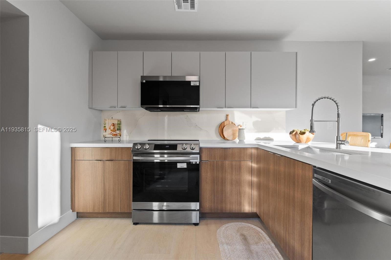 2439 Rodman Street Hollywood, FL 33020 - Photo 12 of 28 a kitchen with a sink appliances and cabinets