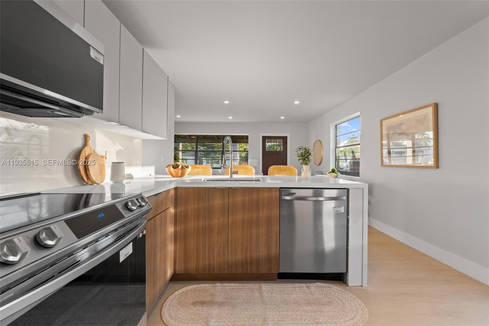 2439 Rodman Street Hollywood, FL 33020 - Photo 13 of 28 a kitchen with stainless steel appliances granite countertop a stove and a sink