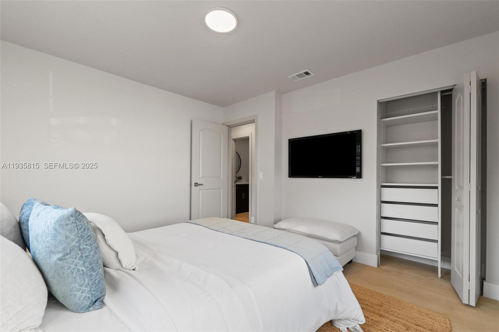 2439 Rodman Street Hollywood, FL 33020 - Photo 19 of 28 a bedroom with a bed and a flat screen tv