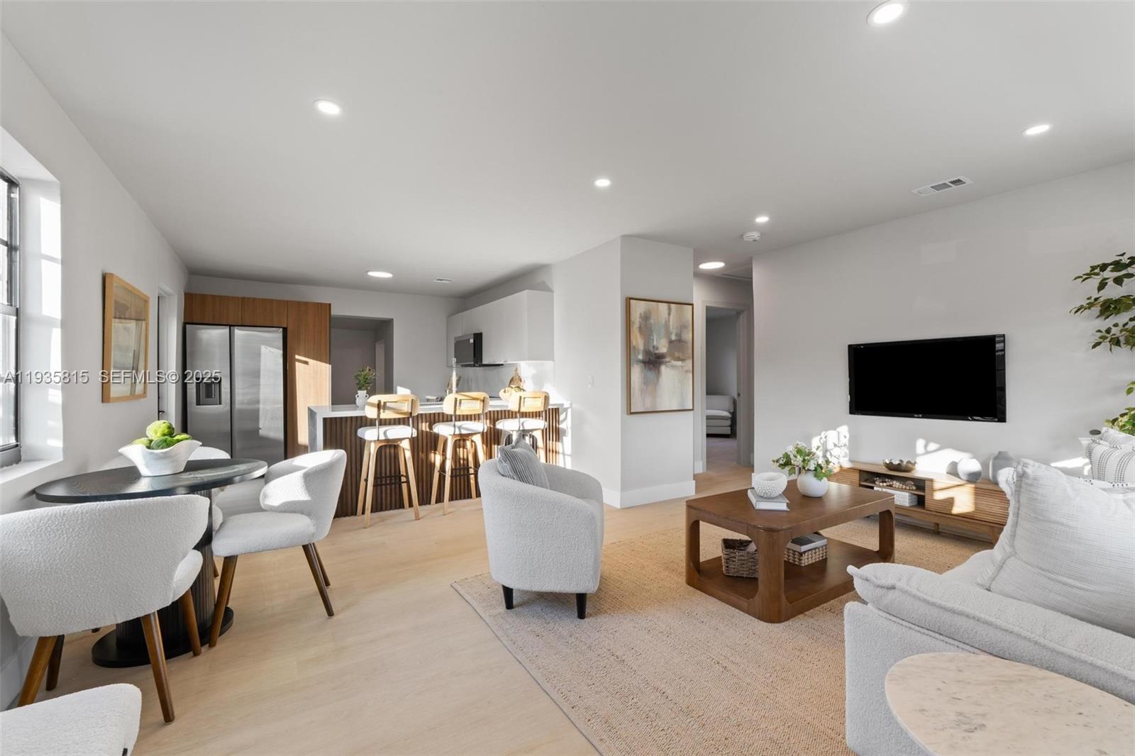 2439 Rodman Street Hollywood, FL 33020 - Photo 3 of 28 a living room with furniture and a flat screen tv