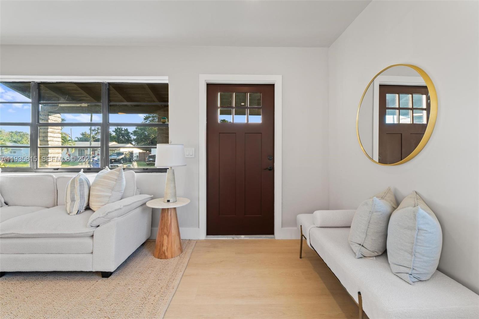 2439 Rodman Street Hollywood, FL 33020 - Photo 4 of 28 a living room with furniture a mirror and a large window