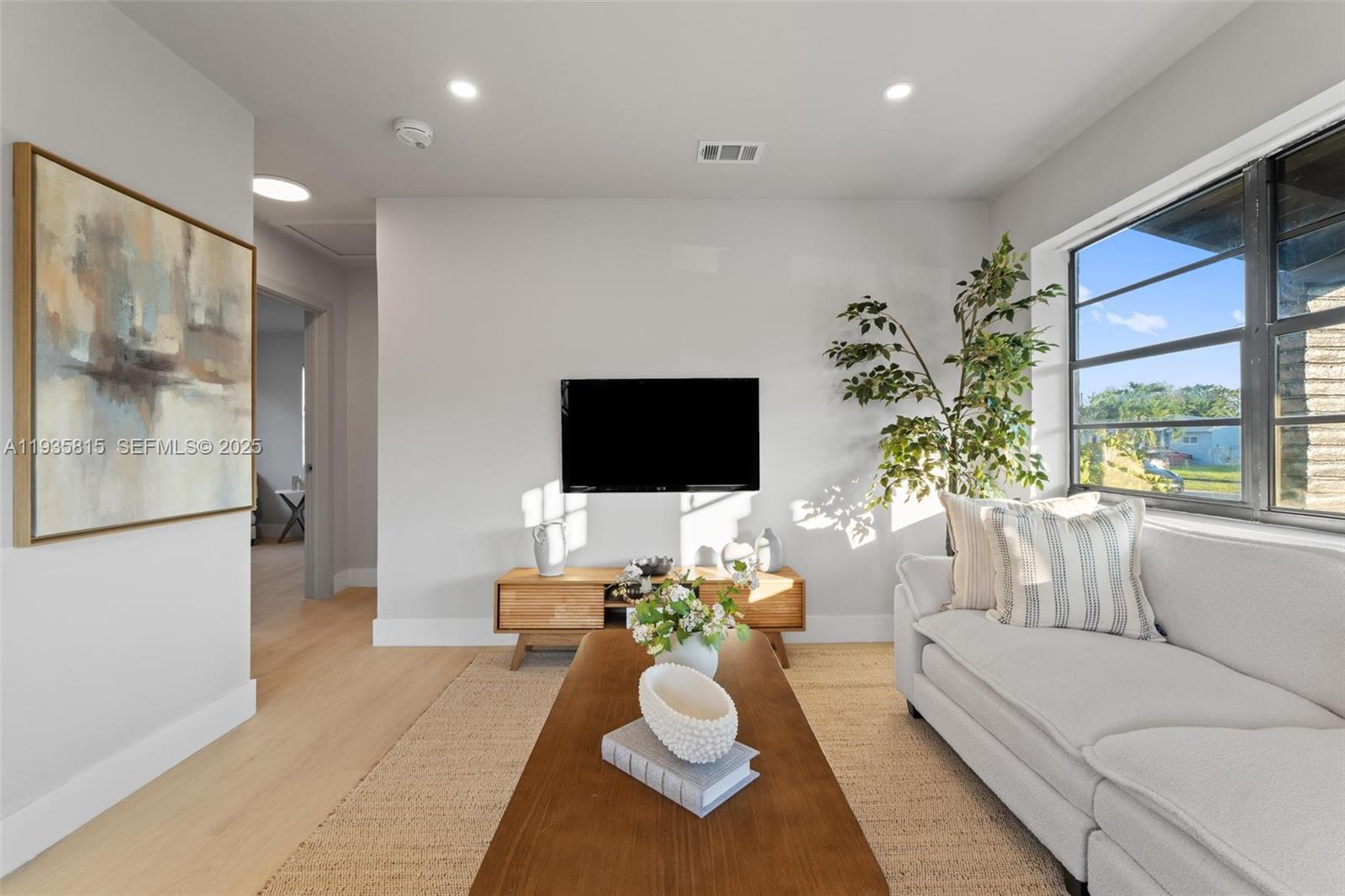 2439 Rodman Street Hollywood, FL 33020 - Photo 8 of 28 a living room with furniture and a flat screen tv