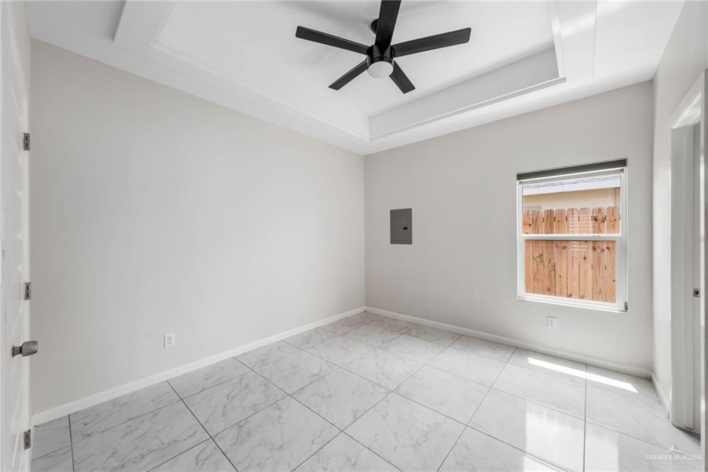5805 Puffin Avenue, Unit 1 Mission, TX 78573 - Photo 5 of 7 an empty room with windows and fan