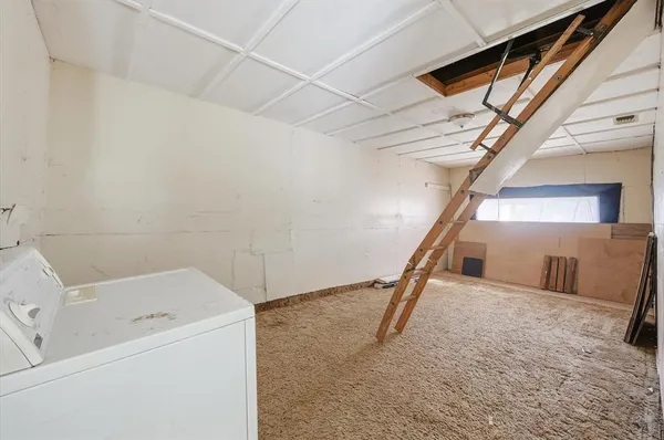 a view of a storage & utility room with stairs