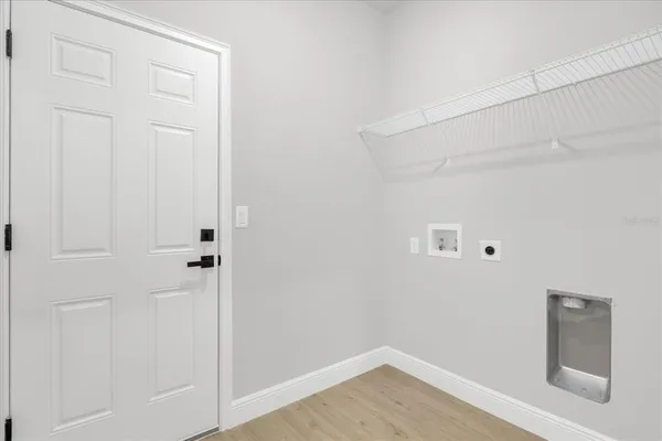 a view of a storage & utility room with a wooden floor