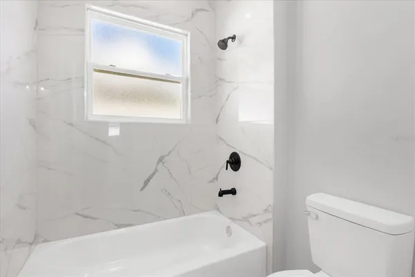 a bathroom with a bathtub and a toilet