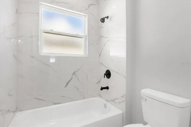 a bathroom with a bathtub and a toilet