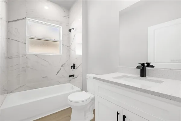 a bathroom with a sink a toilet and a bathtub