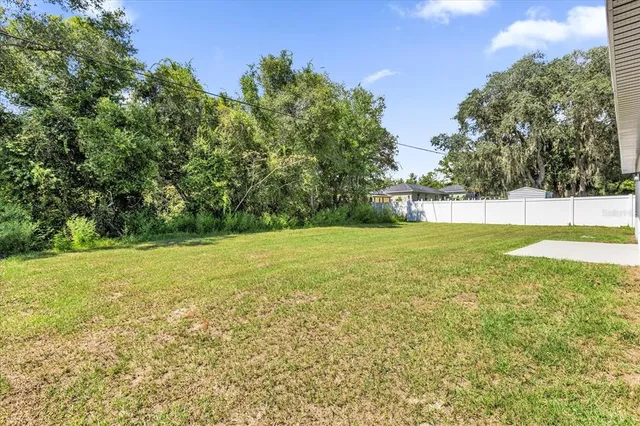 a view of yard with swimming pool and green space