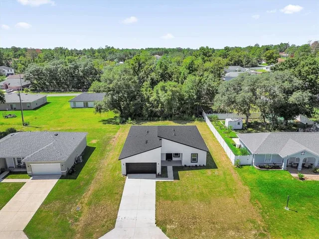 an aerial view of a house with pool