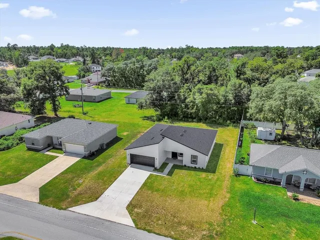 an aerial view of a house with garden space and street view