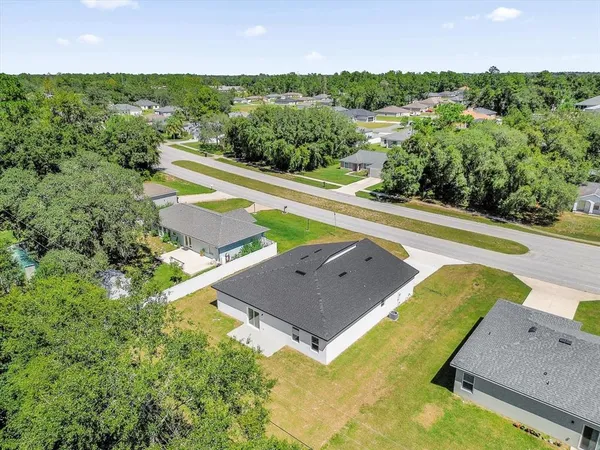 an aerial view of a house with a swimming pool