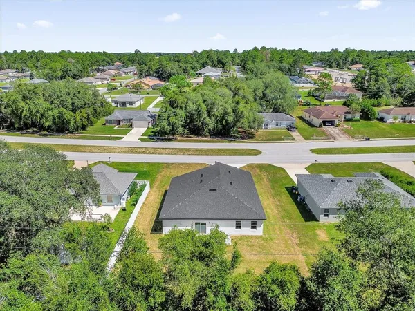 an aerial view of residential houses with outdoor space and swimming pool