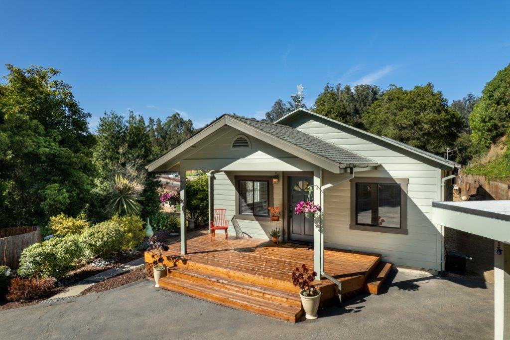a view of a house with backyard porch and sitting area