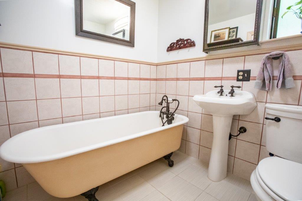 130 Strawberry Road Watsonville, CA 95076 - Photo 14 of 27 a bath tub sitting next to a white toilet