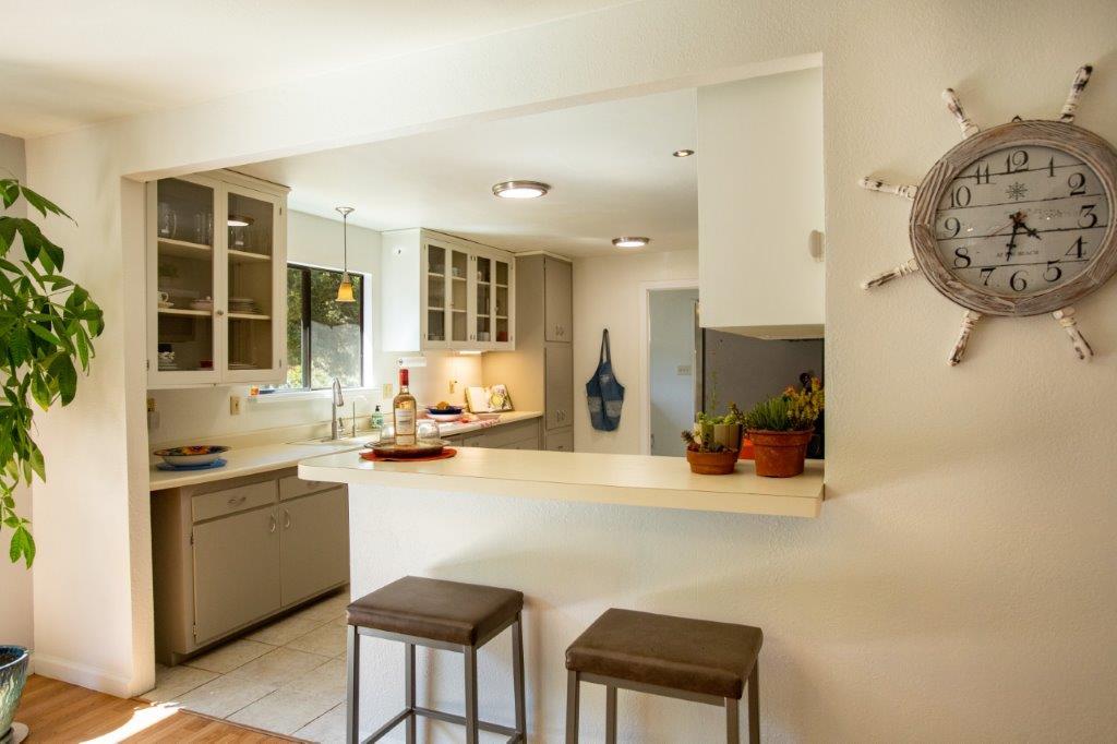 130 Strawberry Road Watsonville, CA 95076 - Photo 5 of 27 a view of a kitchen with a sink and dishwasher a stove with wooden floor
