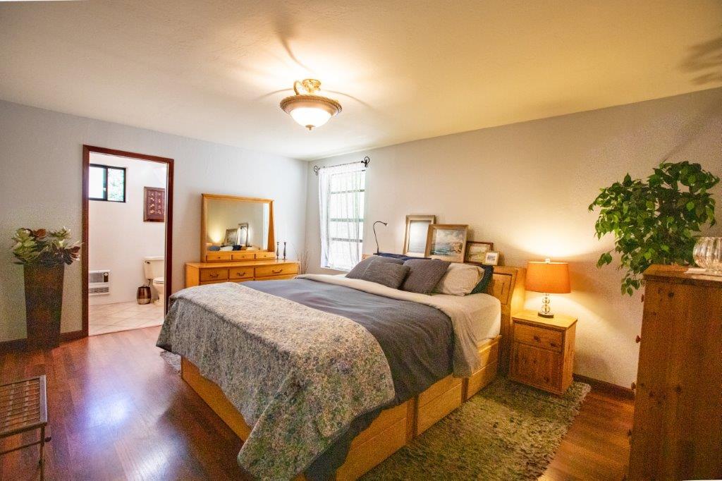 130 Strawberry Road Watsonville, CA 95076 - Photo 9 of 27 a spacious bedroom with a bed and a chandelier