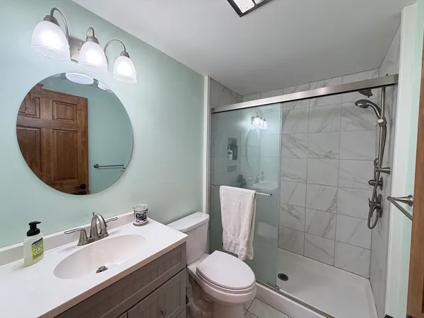 a bathroom with a sink toilet and shower