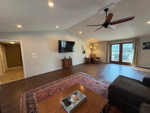 a living room with furniture and a wooden floor